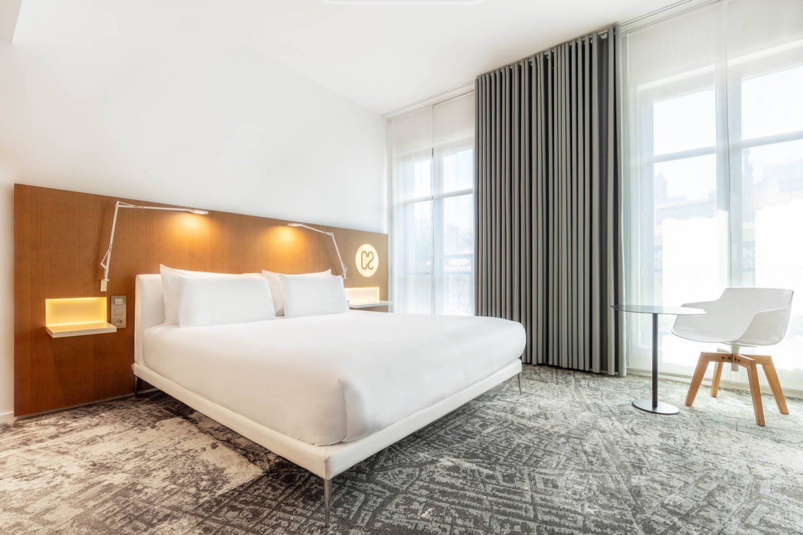 Une chambre de l'Hôtel C2 à Marseille, avec son monogramme lumineux et ses grandes fenêtres